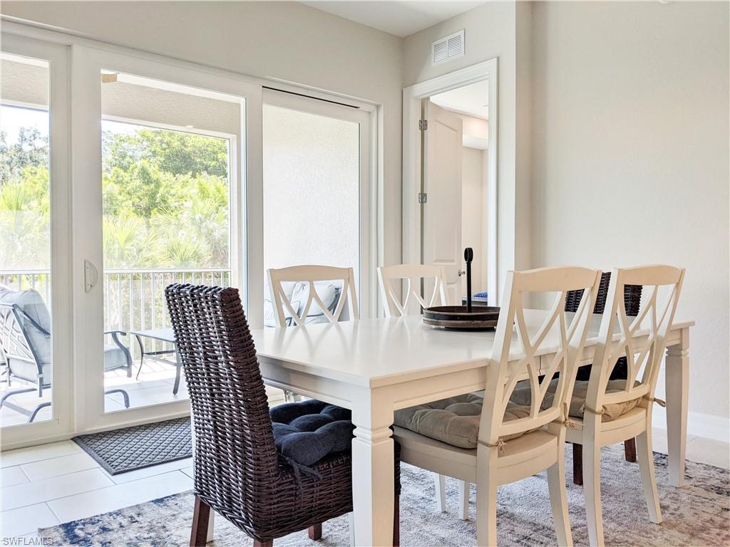 178 Indies Drive East, Unit 201 Naples, FL 34114 - Photo 10 of 31 a view of a dining room with furniture window and outside view