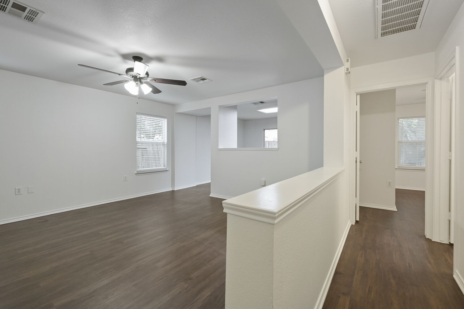 6733 Doyal Drive Austin, TX 78747 - Photo 8 of 28 An airy common area with modern flooring extends into adjacent spaces, perfect for seamless daily living.
