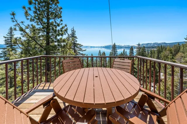a view of a balcony with wooden floor and outdoor seating