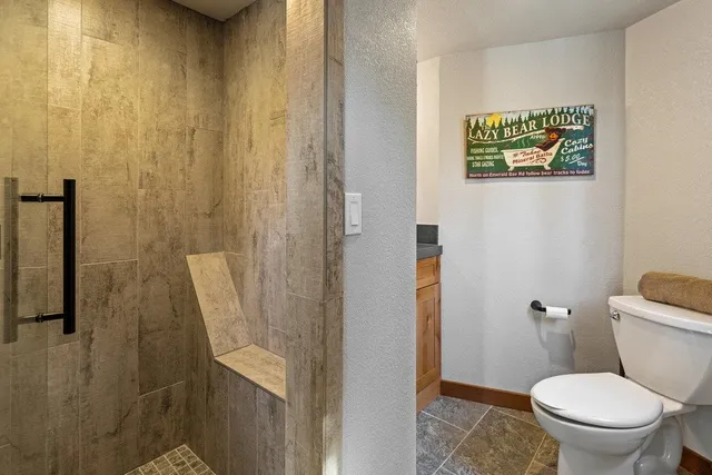 a bathroom with a toilet and a shower