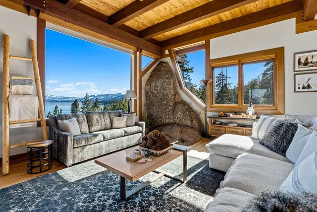 a living room with furniture and a floor to ceiling window