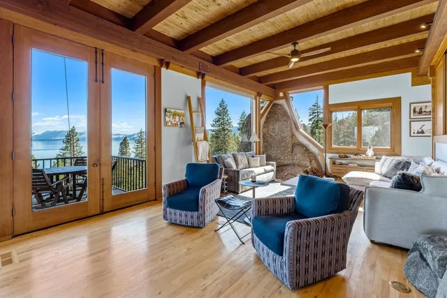 a living room with furniture and a floor to ceiling window