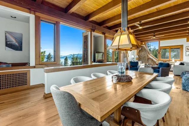 a dining room with furniture a chandelier and wooden floor