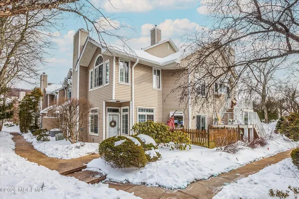 a view of a house with a yard covered in snow