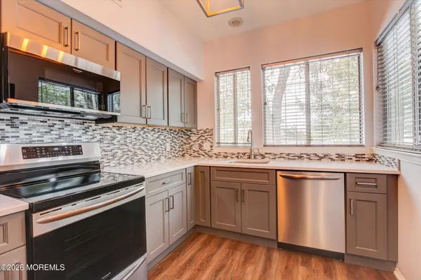 a kitchen with stainless steel appliances a stove sink and cabinets