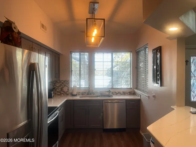 a bathroom with a shower sink and mirror