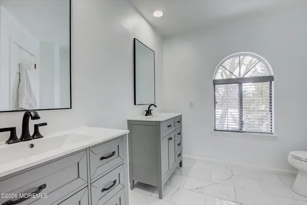a bathroom with a sink double vanity and a mirror
