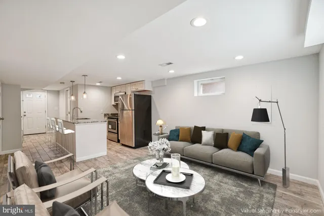 a view of kitchen with refrigerator cabinets and wooden floor