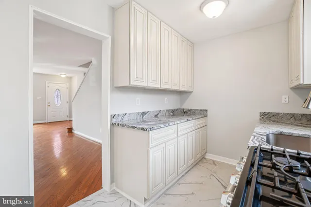 a kitchen with granite countertop a stove and a sink