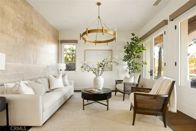 a living room with furniture and a chandelier