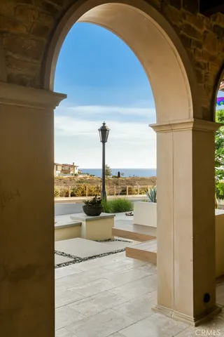 a living room with stainless steel appliances kitchen island granite countertop a stove and white cabinets