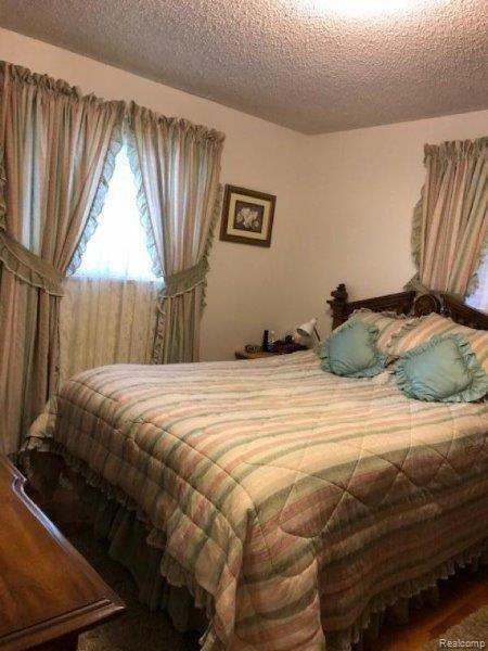 3961 Washburn Road Vassar, MI 48768 - Photo 14 of 25 The larger bedroom with hardwood flooring.