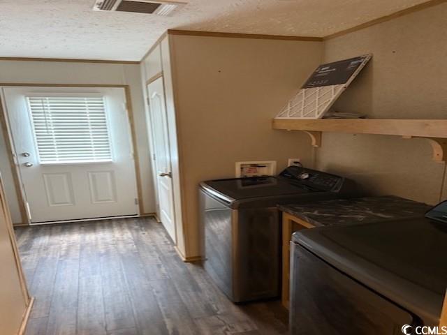65 Clemmons Drive Tabor City, NC 28463 - Photo 20 of 29 Laundry area with washer and dryer, wood-type flooring, ornamental molding, and a textured ceiling