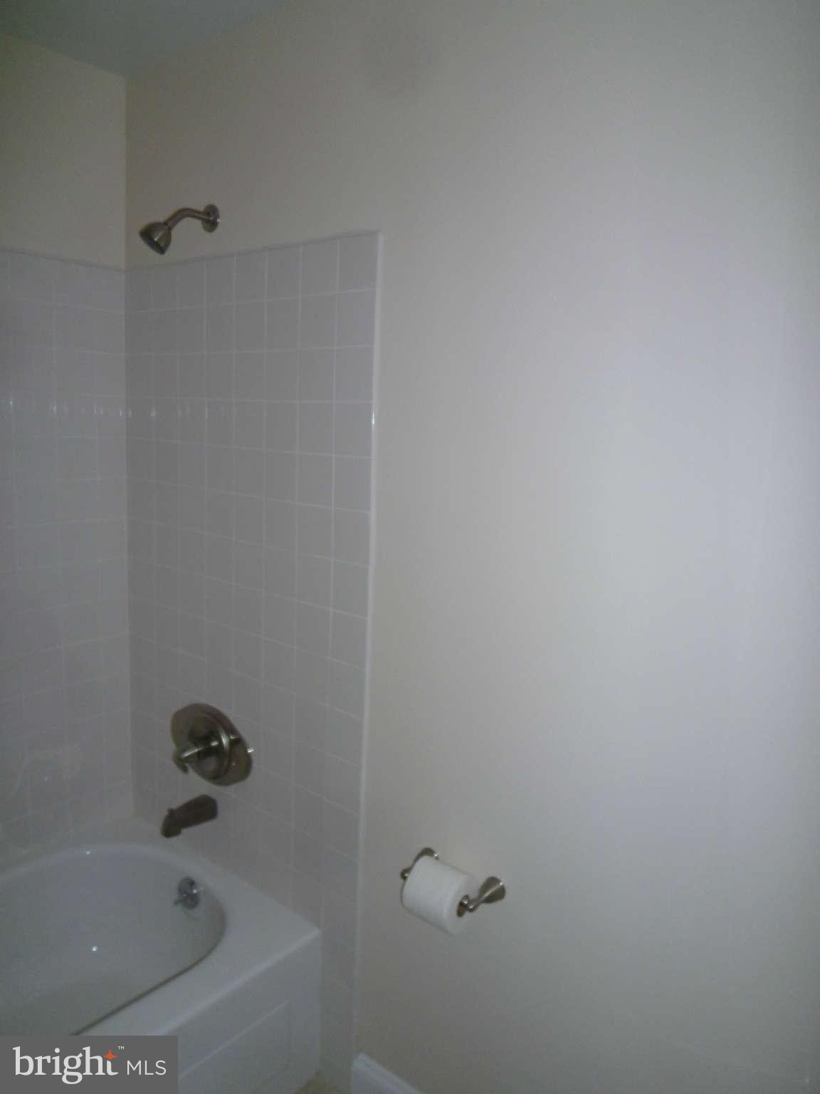 7205 Johnnycake Road Baltimore, MD 21228 - Photo 14 of 14 a bathroom with a bathtub
