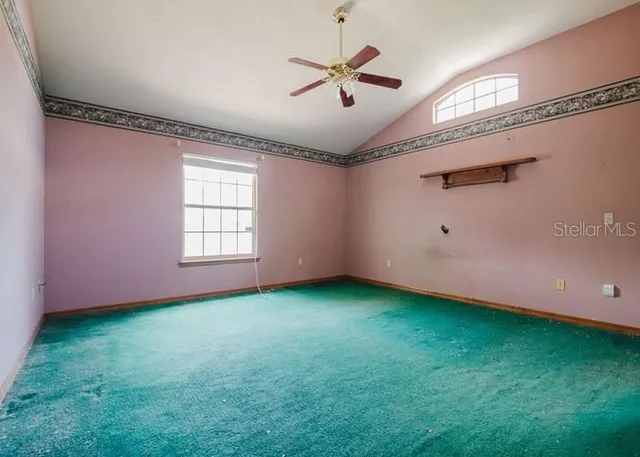 a view of a room with window and a ceiling fan