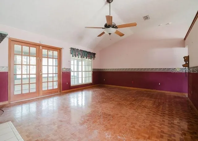 a view of a livingroom with a ceiling fan and window