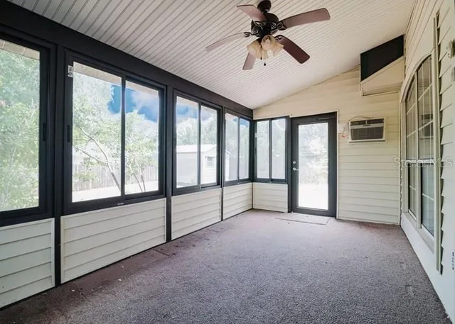 a view of a livingroom with a ceiling fan and window