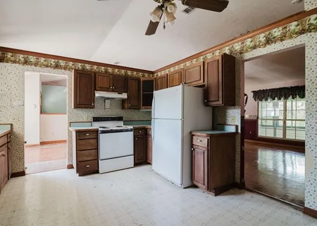 a kitchen with a refrigerator and a stove