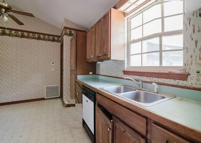 a kitchen with a sink and a refrigerator