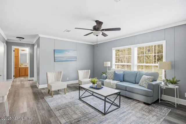 a living room with furniture and a large window