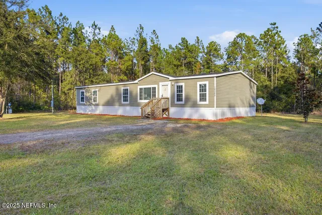 a view of a house with a big yard
