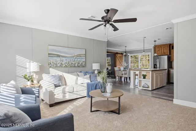 a living room with furniture and a ceiling fan