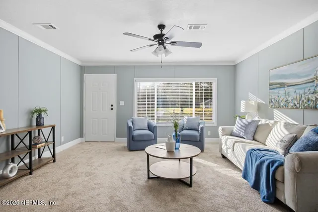a living room with furniture and a large window