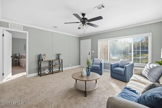 a living room with furniture and a large window