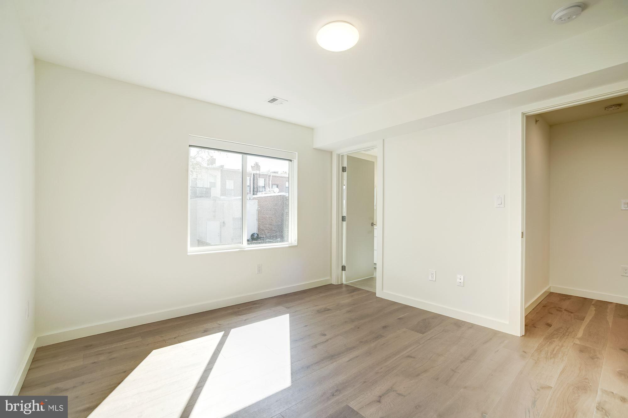 446 Ridge Street Northwest Washington, DC 20001 - Photo 16 of 24 an empty room with wooden floor and windows