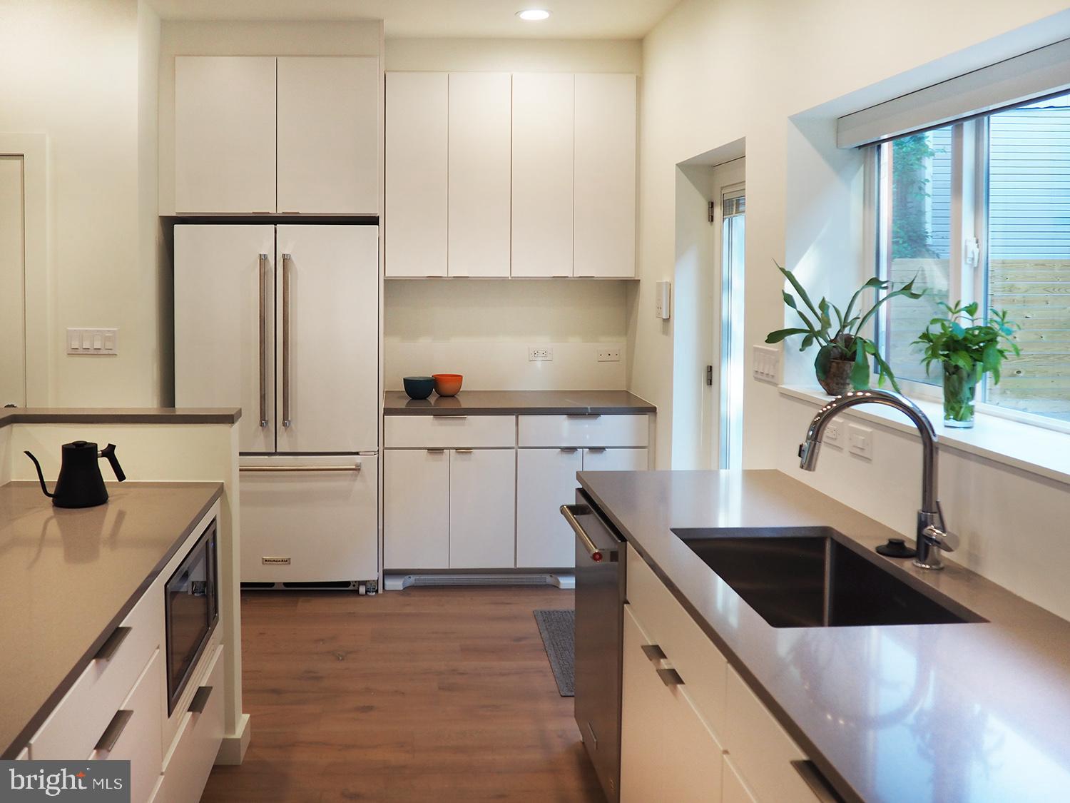 446 Ridge Street Northwest Washington, DC 20001 - Photo 21 of 24 a kitchen that has a sink cabinets counter space and appliances