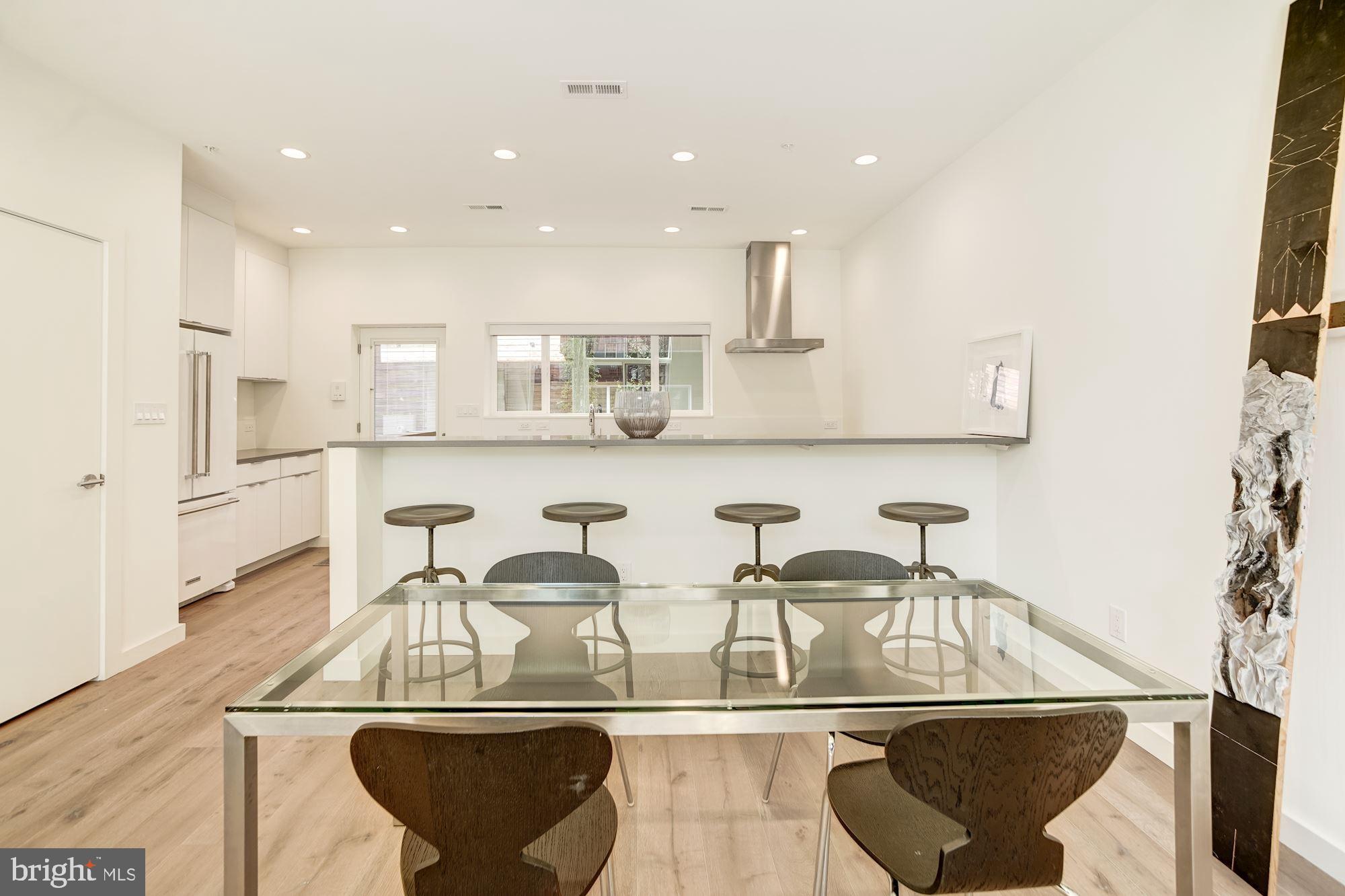 446 Ridge Street Northwest Washington, DC 20001 - Photo 9 of 24 a view of a kitchen with kitchen island granite countertop a table and chairs
