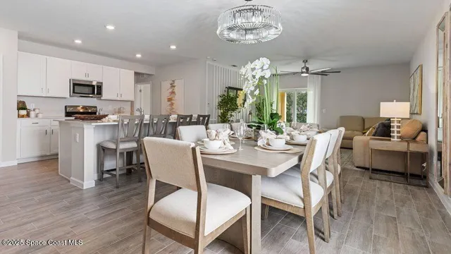 a view of a dining room with furniture and wooden floor
