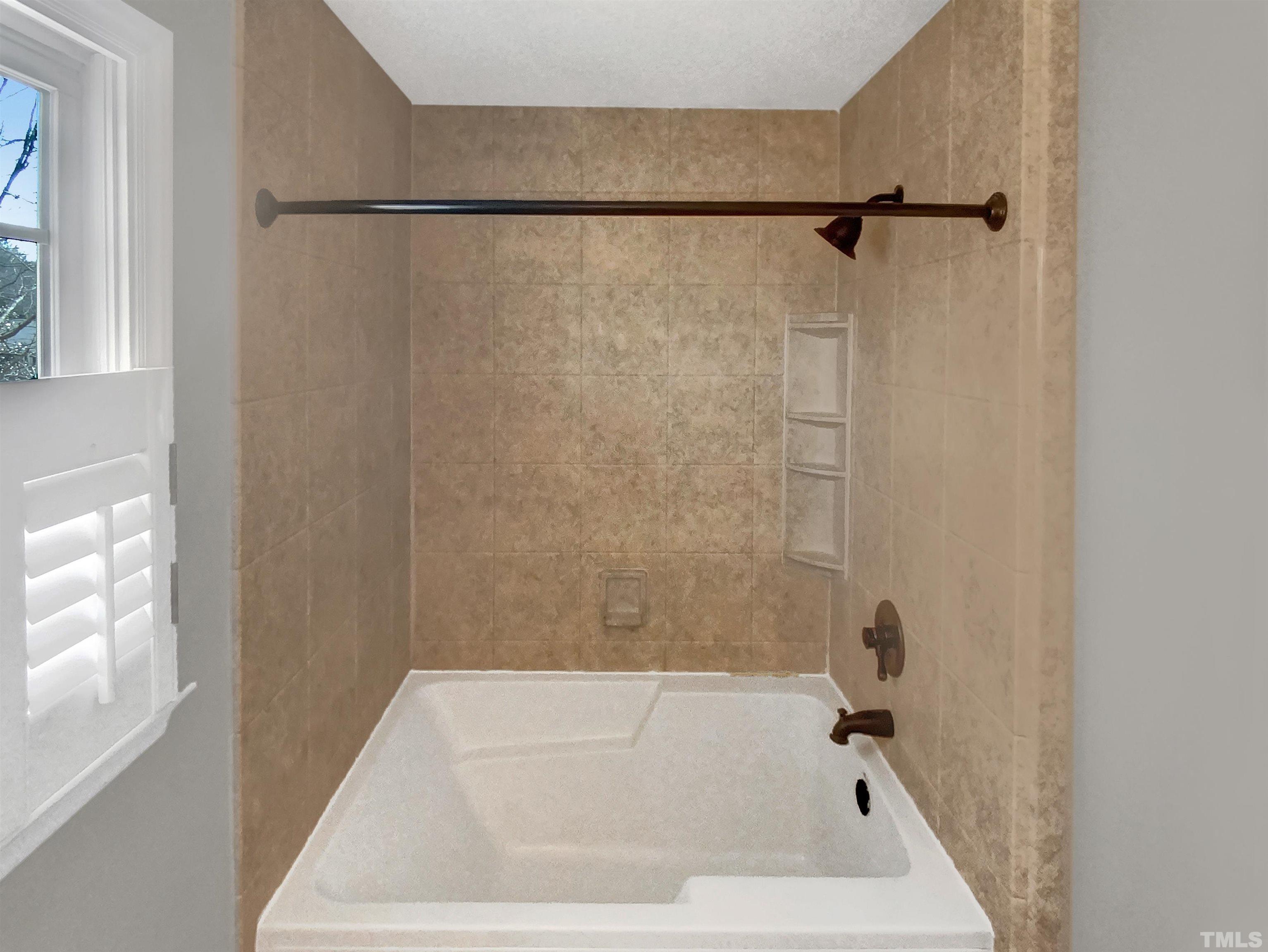 3216 Leebrook Road Raleigh, NC 27616 - Photo 12 of 17 a bathroom with a shower and a bath tub