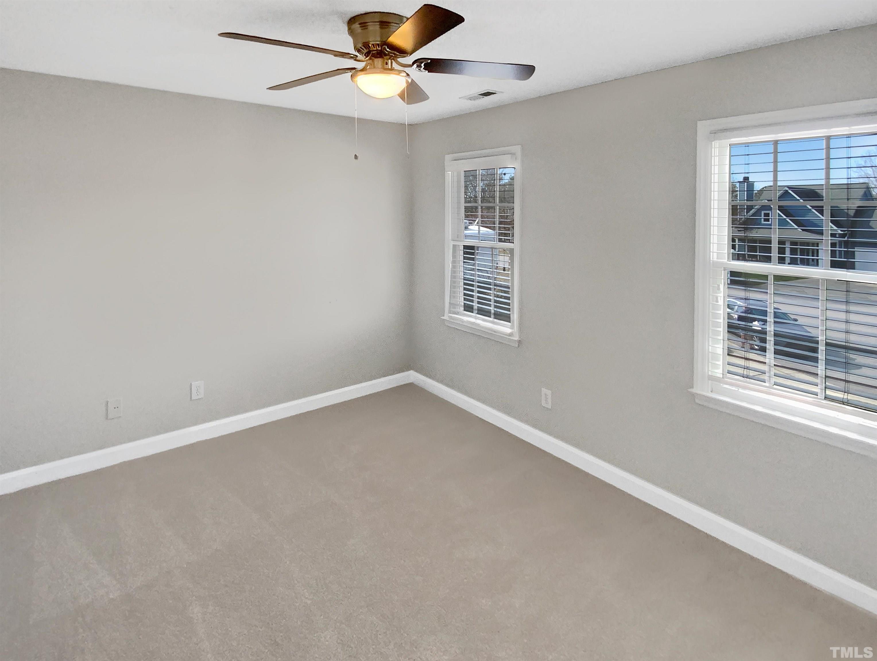 3216 Leebrook Road Raleigh, NC 27616 - Photo 13 of 17 an empty room with a window and a fan