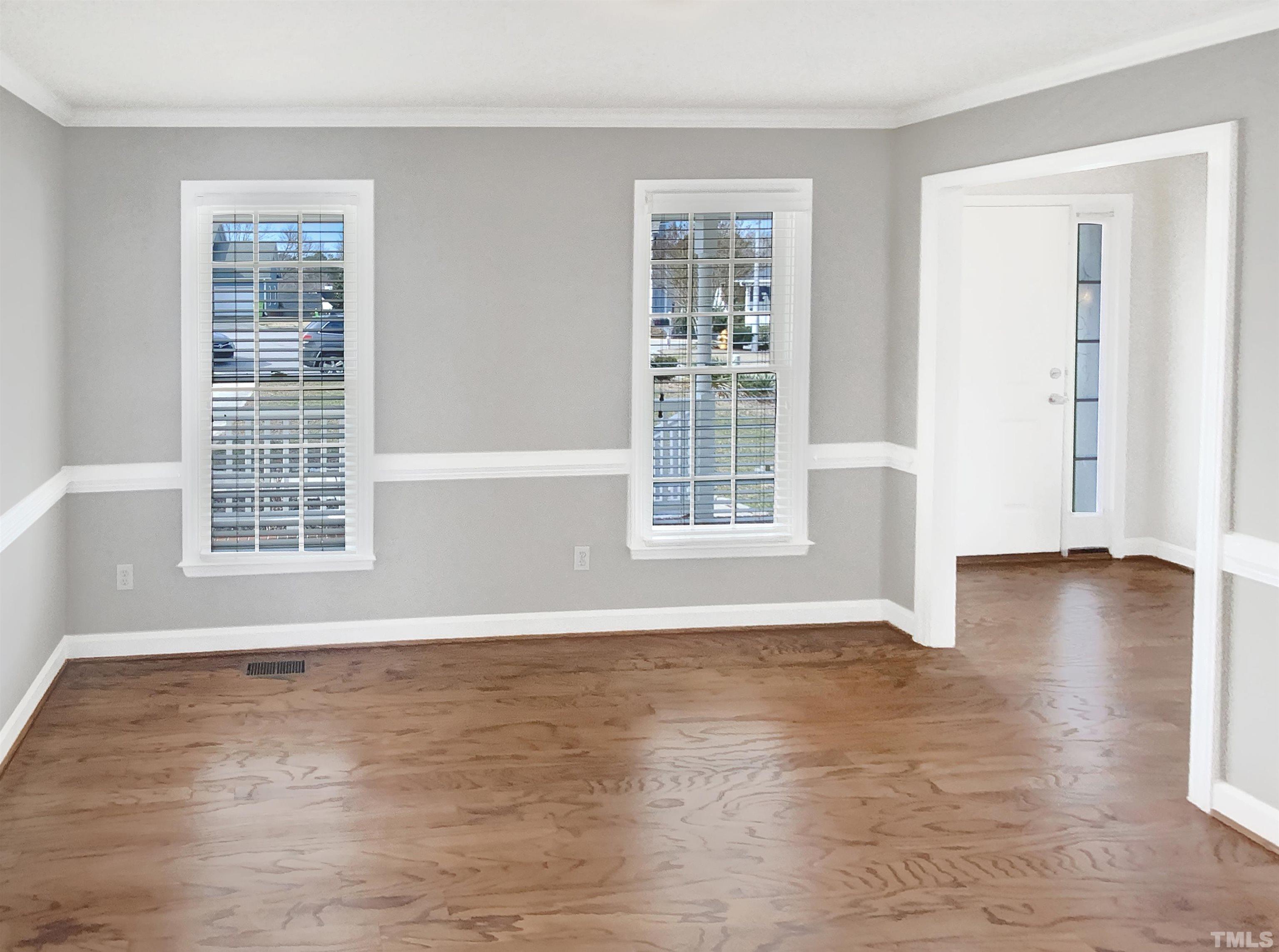 3216 Leebrook Road Raleigh, NC 27616 - Photo 2 of 17 a view of an empty room with wooden floor and a window