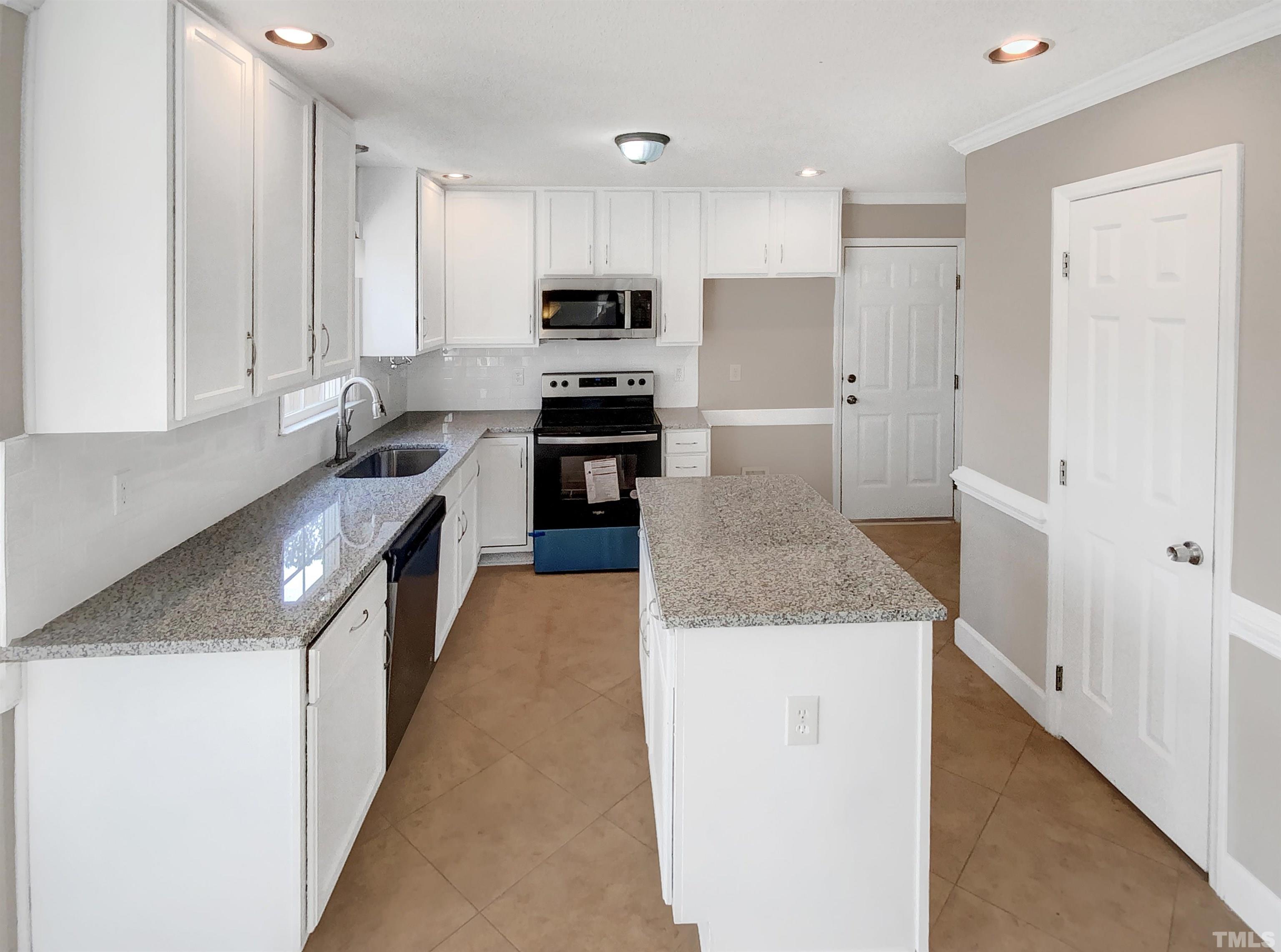 3216 Leebrook Road Raleigh, NC 27616 - Photo 7 of 17 a kitchen with stainless steel appliances granite countertop a sink stove and refrigerator