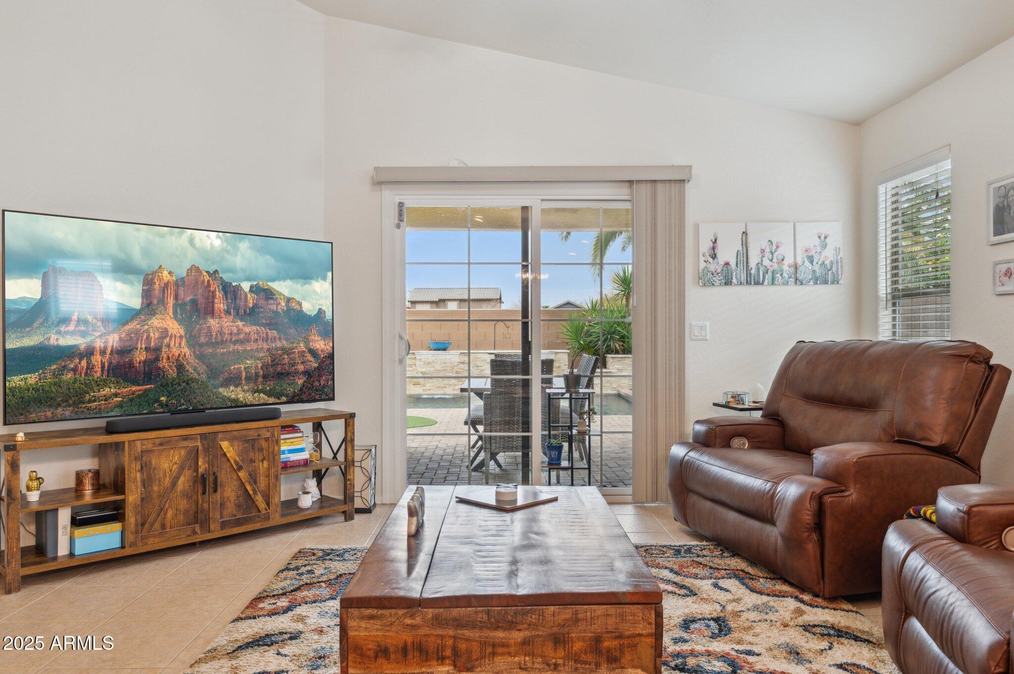 411 West Gascon Road San Tan Valley, AZ 85143 - Photo 11 of 30 a living room with furniture and a floor to ceiling window