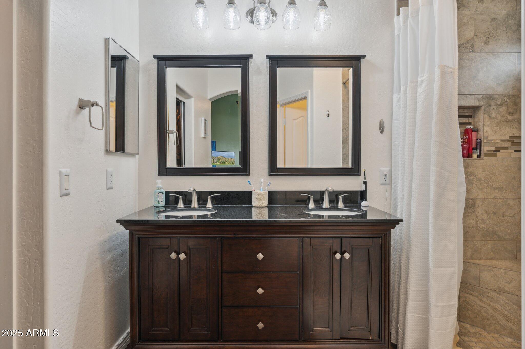 411 West Gascon Road San Tan Valley, AZ 85143 - Photo 15 of 30 a bathroom with a granite countertop sink and a mirror