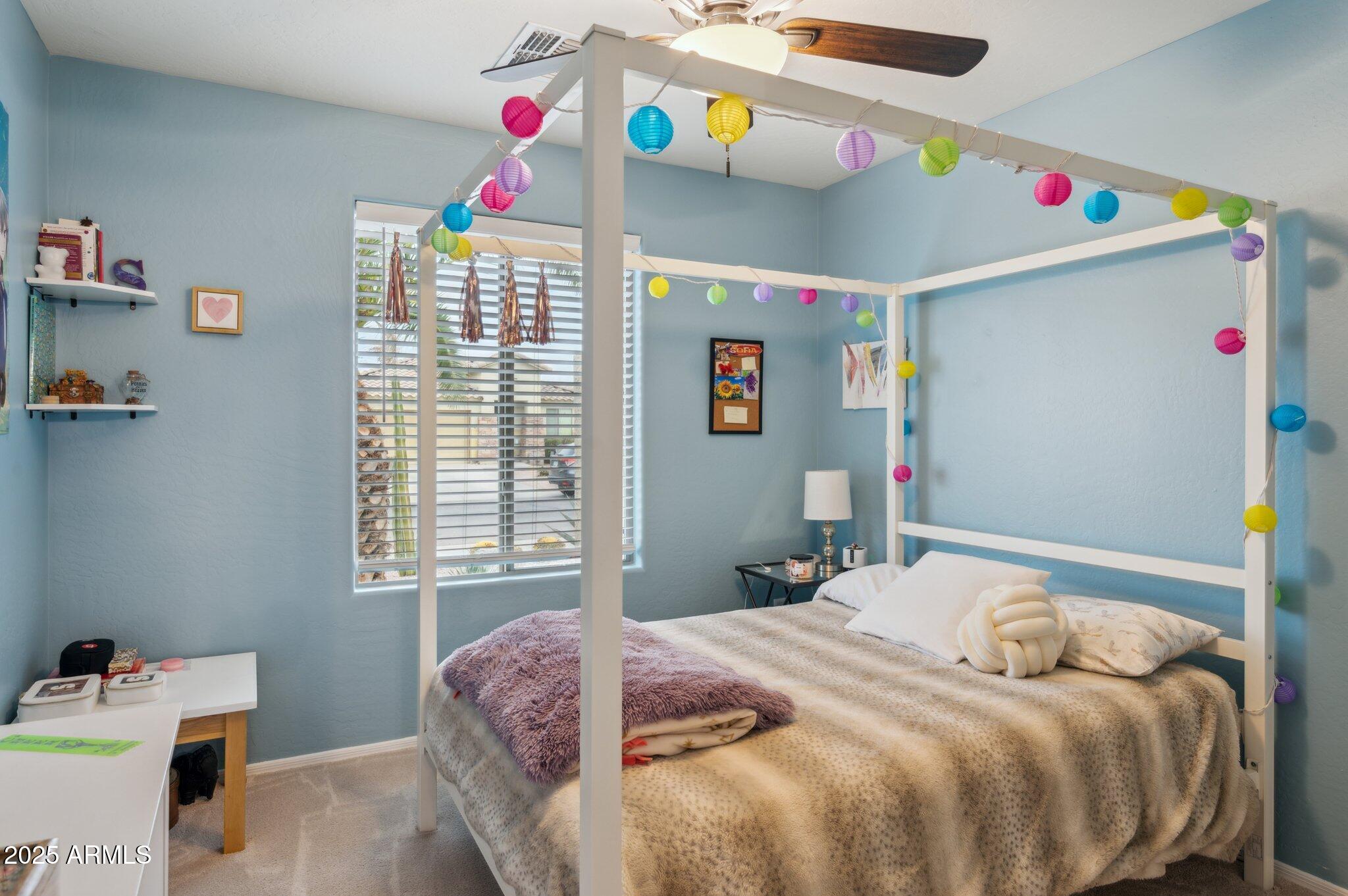 411 West Gascon Road San Tan Valley, AZ 85143 - Photo 17 of 30 a bedroom with a bed a dresser and a window