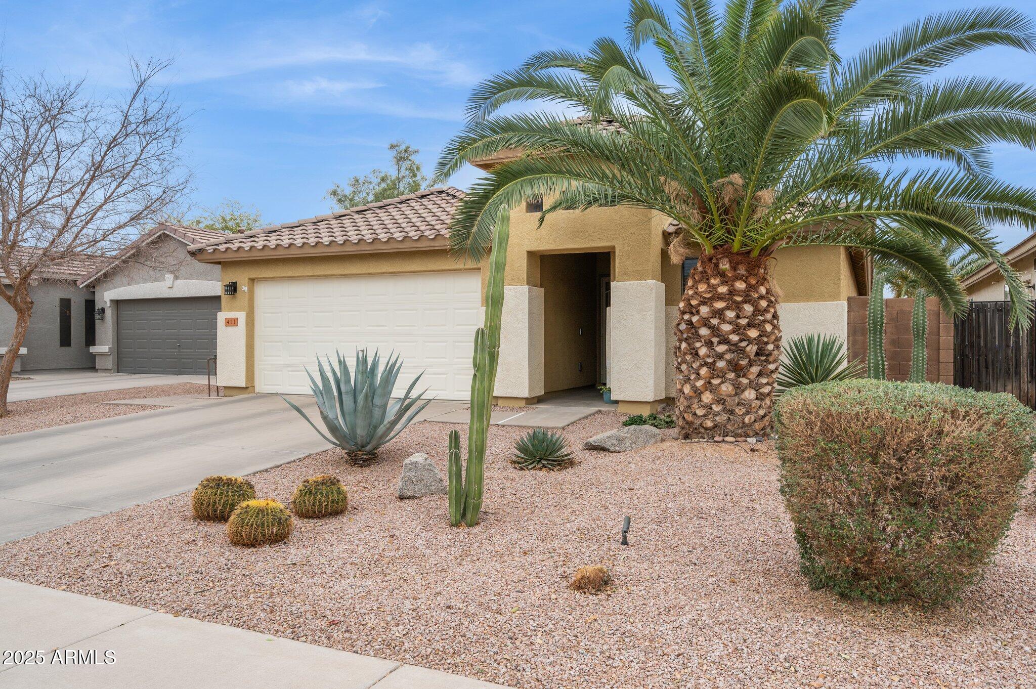 411 West Gascon Road San Tan Valley, AZ 85143 - Photo 2 of 30 a front view of a house with garden