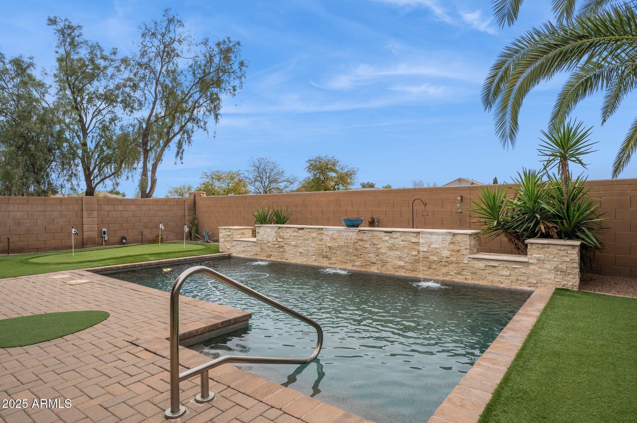 411 West Gascon Road San Tan Valley, AZ 85143 - Photo 27 of 30 a view of a swimming pool with a patio and a yard