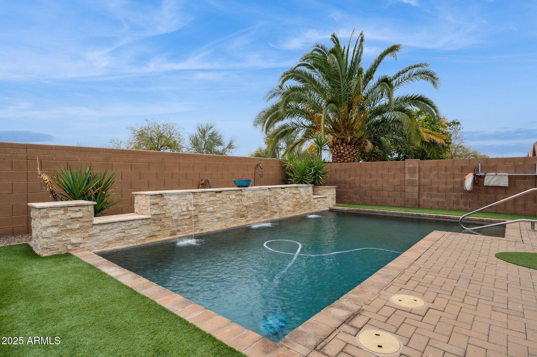 411 West Gascon Road San Tan Valley, AZ 85143 - Photo 28 of 30 a view of a swimming pool with a yard