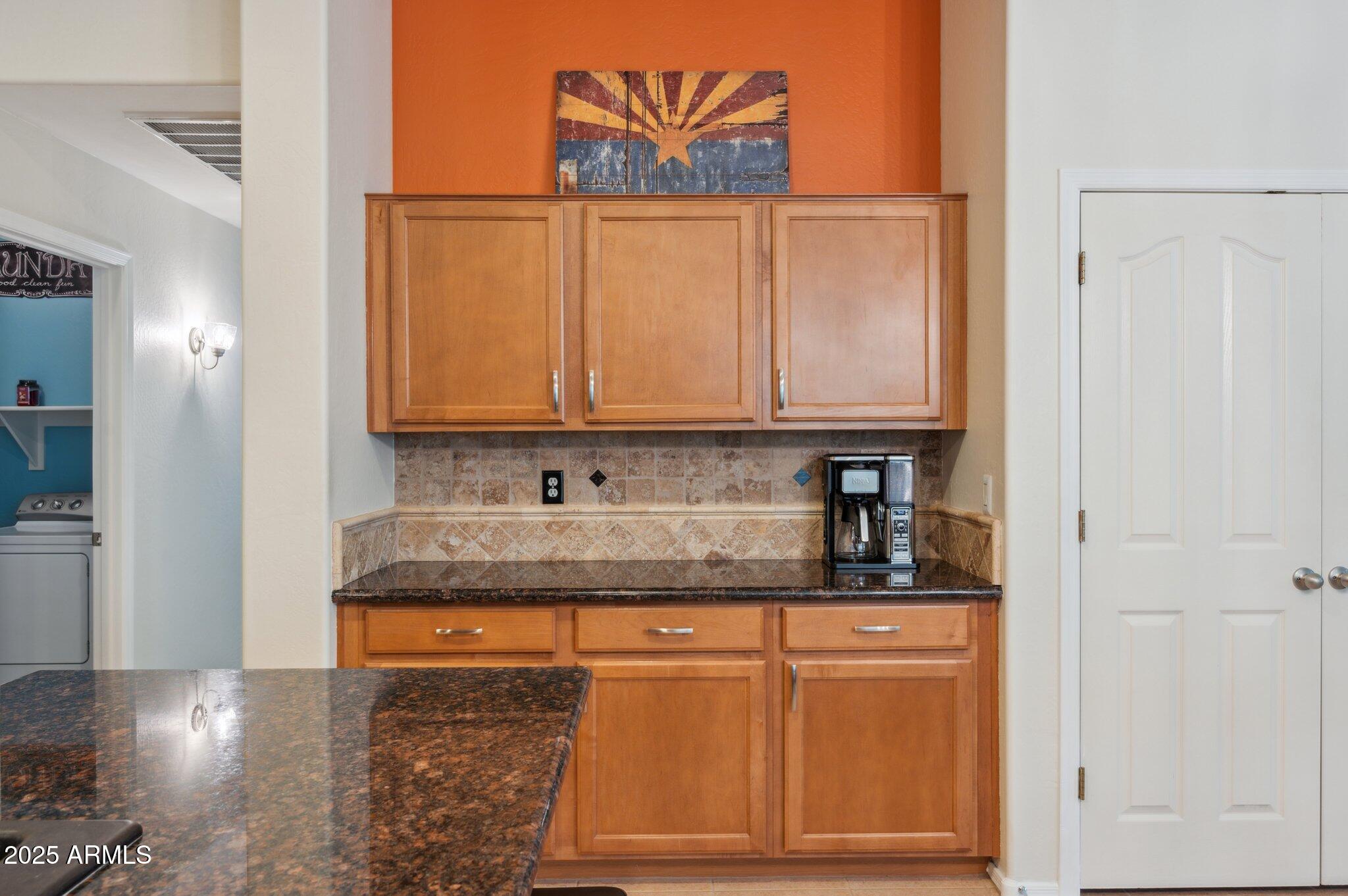 411 West Gascon Road San Tan Valley, AZ 85143 - Photo 6 of 30 a kitchen with granite countertop cabinets and black appliances