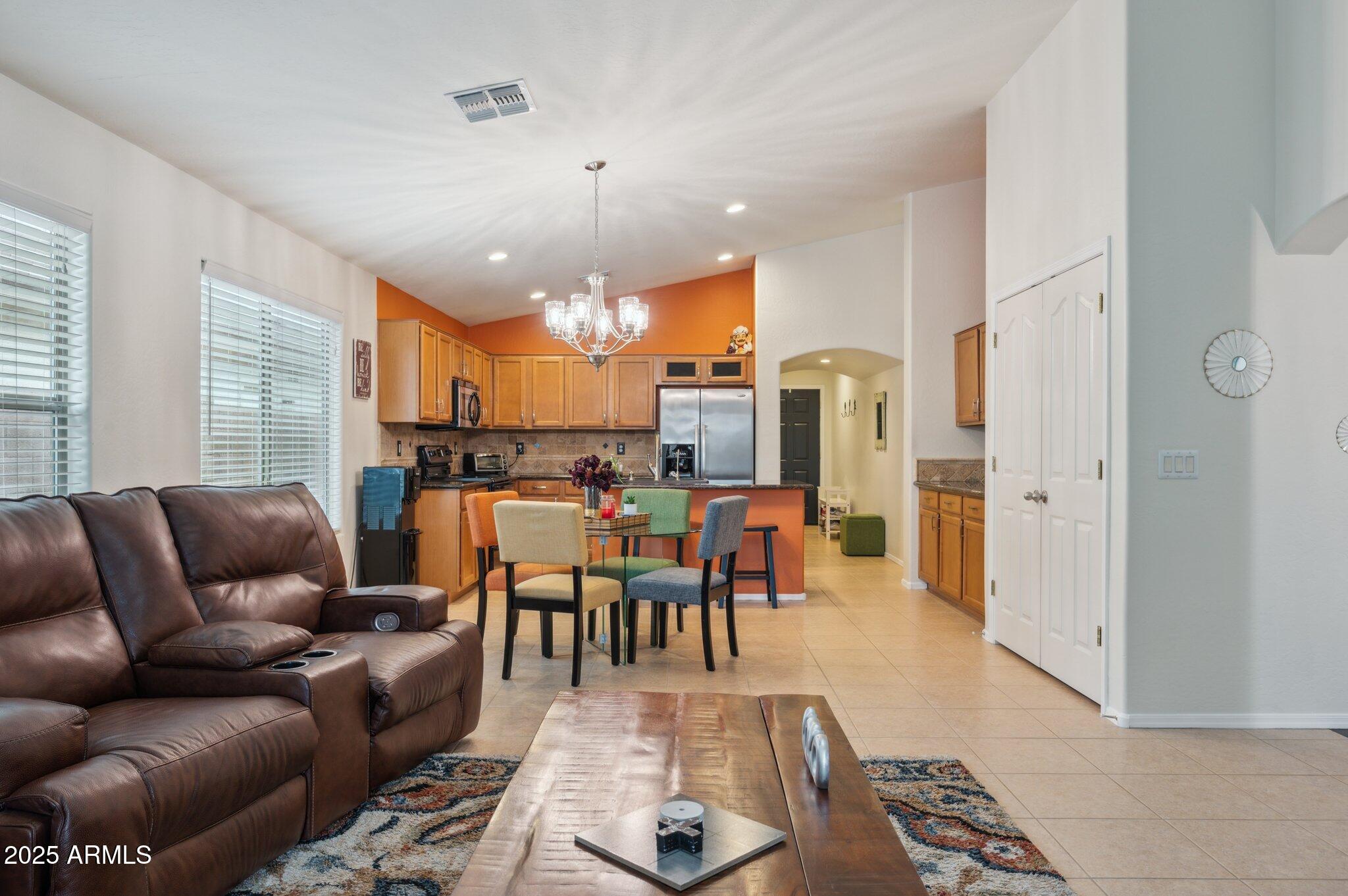 411 West Gascon Road San Tan Valley, AZ 85143 - Photo 8 of 30 a living room with furniture kitchen view and a chandelier