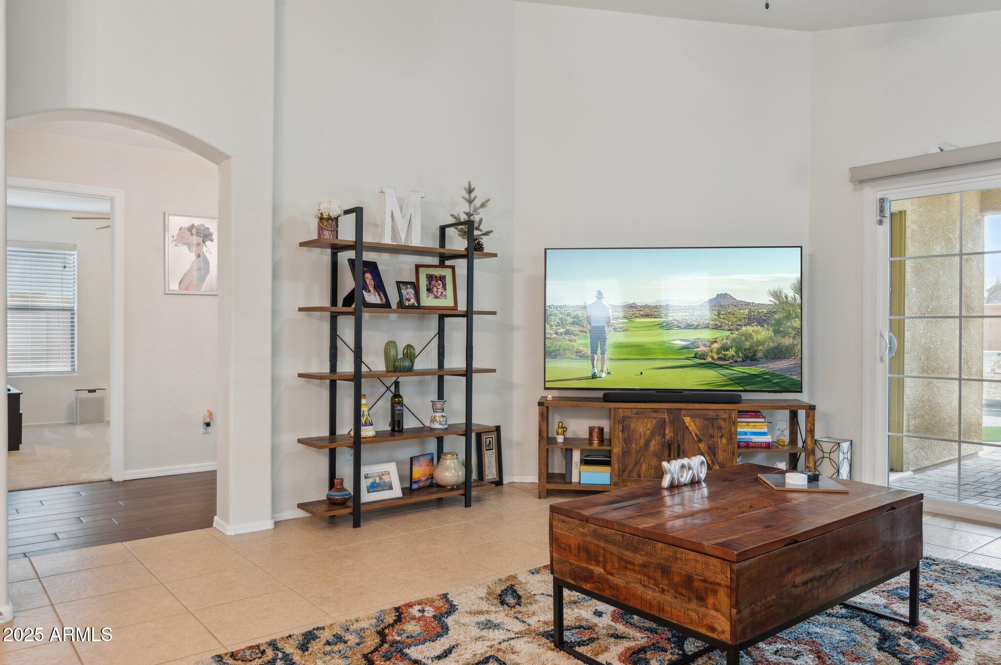 411 West Gascon Road San Tan Valley, AZ 85143 - Photo 10 of 30 a living room with furniture and a flat screen tv