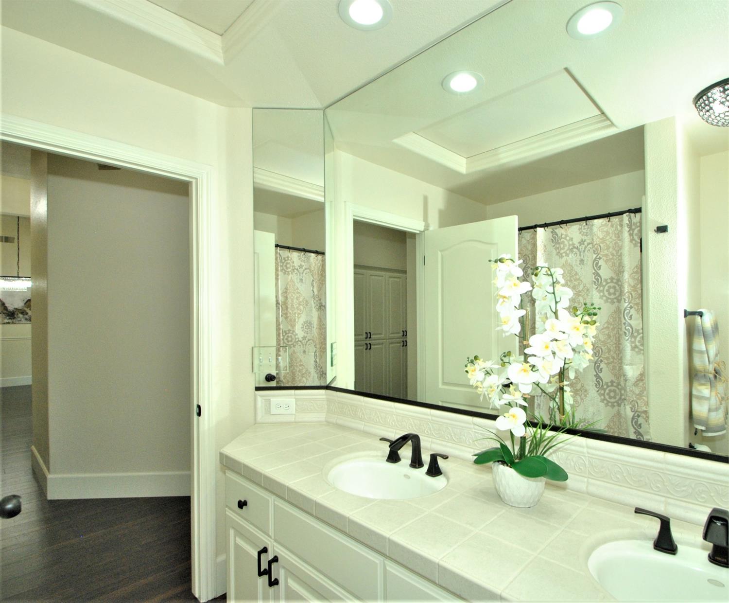 10584 Keats Avenue Clovis, CA 93619 - Photo 32 of 72 a bathroom with a double vanity sink and a mirror