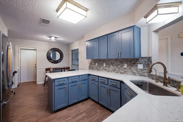 a kitchen with a sink cabinets and stainless steel appliances