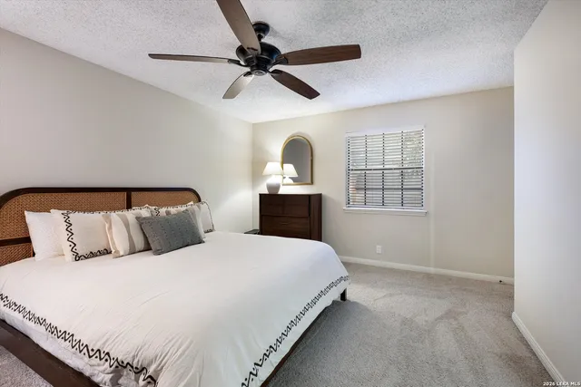 a bedroom with bed and window