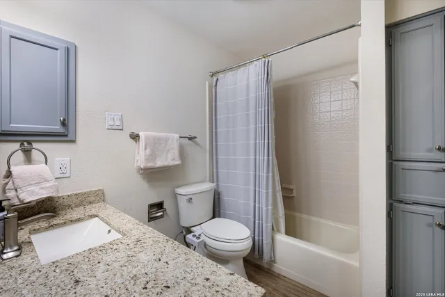 a bathroom with a sink toilet and shower