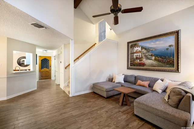 a living room with furniture and wooden floor